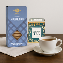 Close-up of Reid’s white chocolate & hazelnut shortbread next to a 10-teabag English Afternoon tea carton