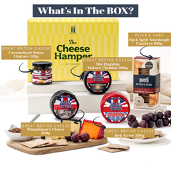 Festive cheese hamper with chutneys, biscuits, and ribbon packaging
