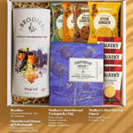 Top-down flat lay of Scottish hamper contents on a white surface, including tea, shortbread, and biscuits.