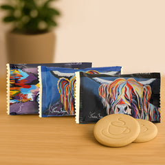 Trio of Dean’s Steven Brown Shortbread Thins, each pack showcasing colourful Highland cow artwork
