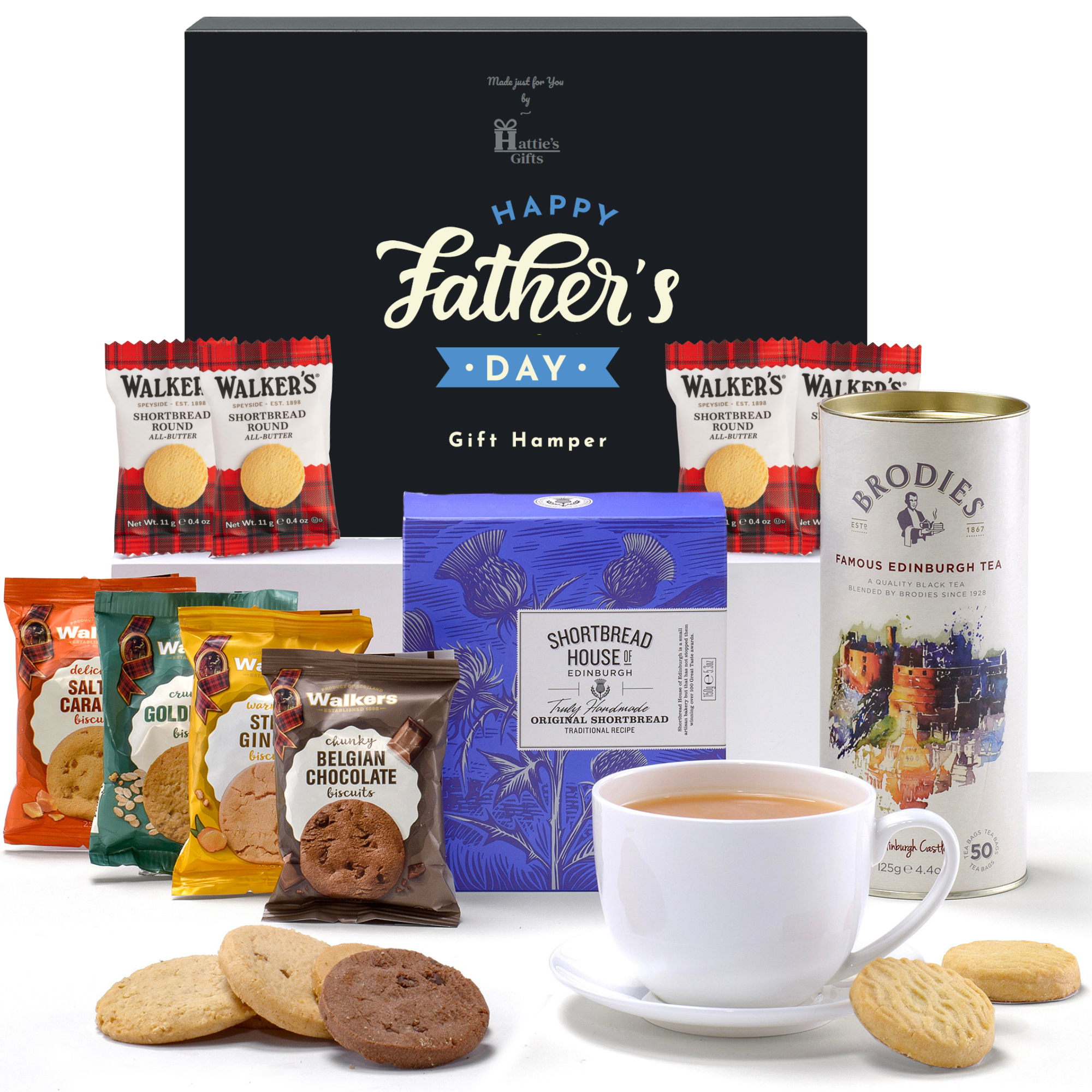 A navy Hattie’s Gifts box labeled ‘Happy Father’s Day Gift Hamper’ on a white surface, surrounded by assorted Walker’s shortbread packets, a Shortbread House of Edinburgh box, a Brodies Edinburgh tea tin, a white cup of tea on a saucer and loose biscuits artfully arranged around the hamper