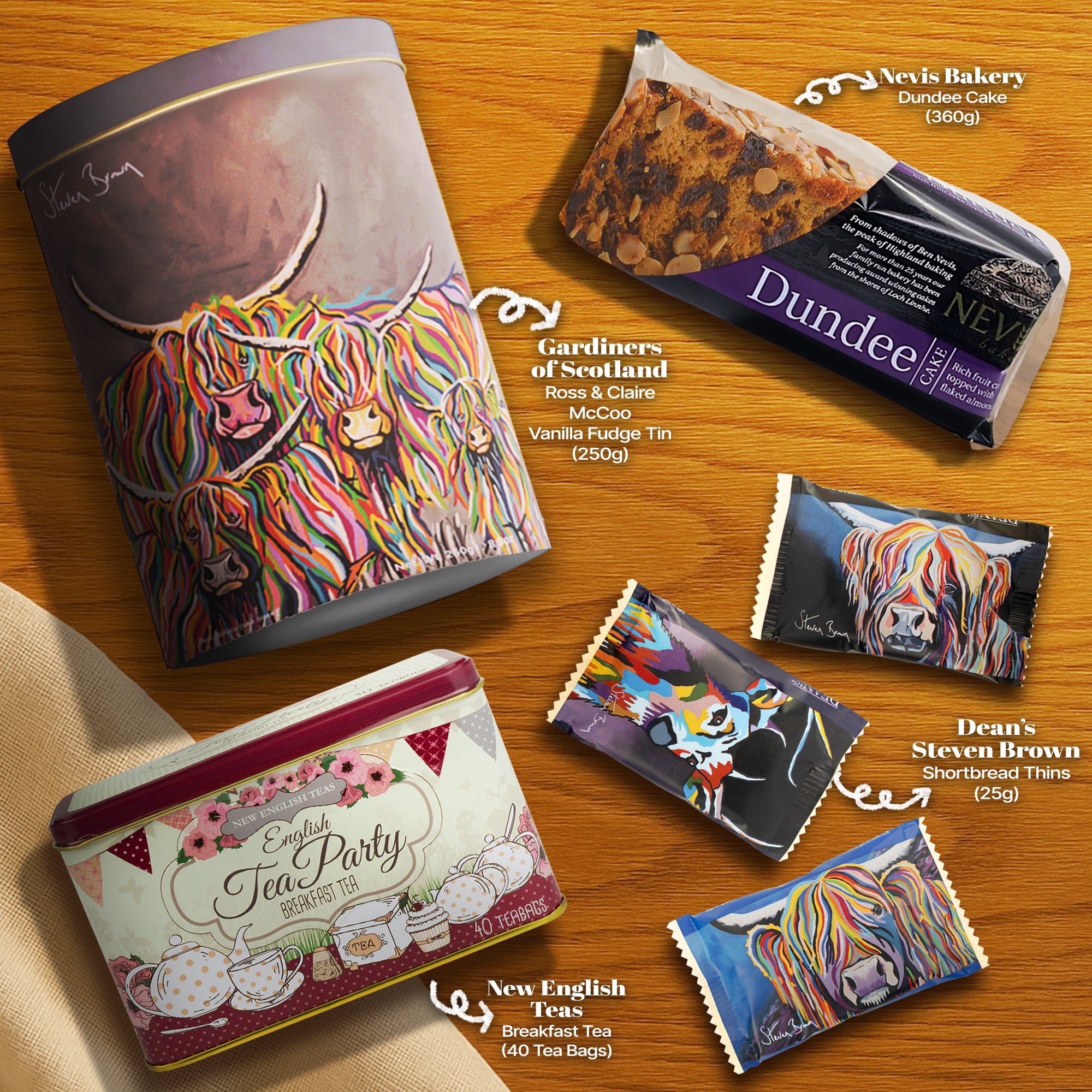 Flat lay of Hattie’s Gifts hamper contents featuring Ross & Claire Vanilla Fudge tin by Gardiners of Scotland, paired with tea, cake, and shortbread—elegantly arranged with the white spotty sleeve