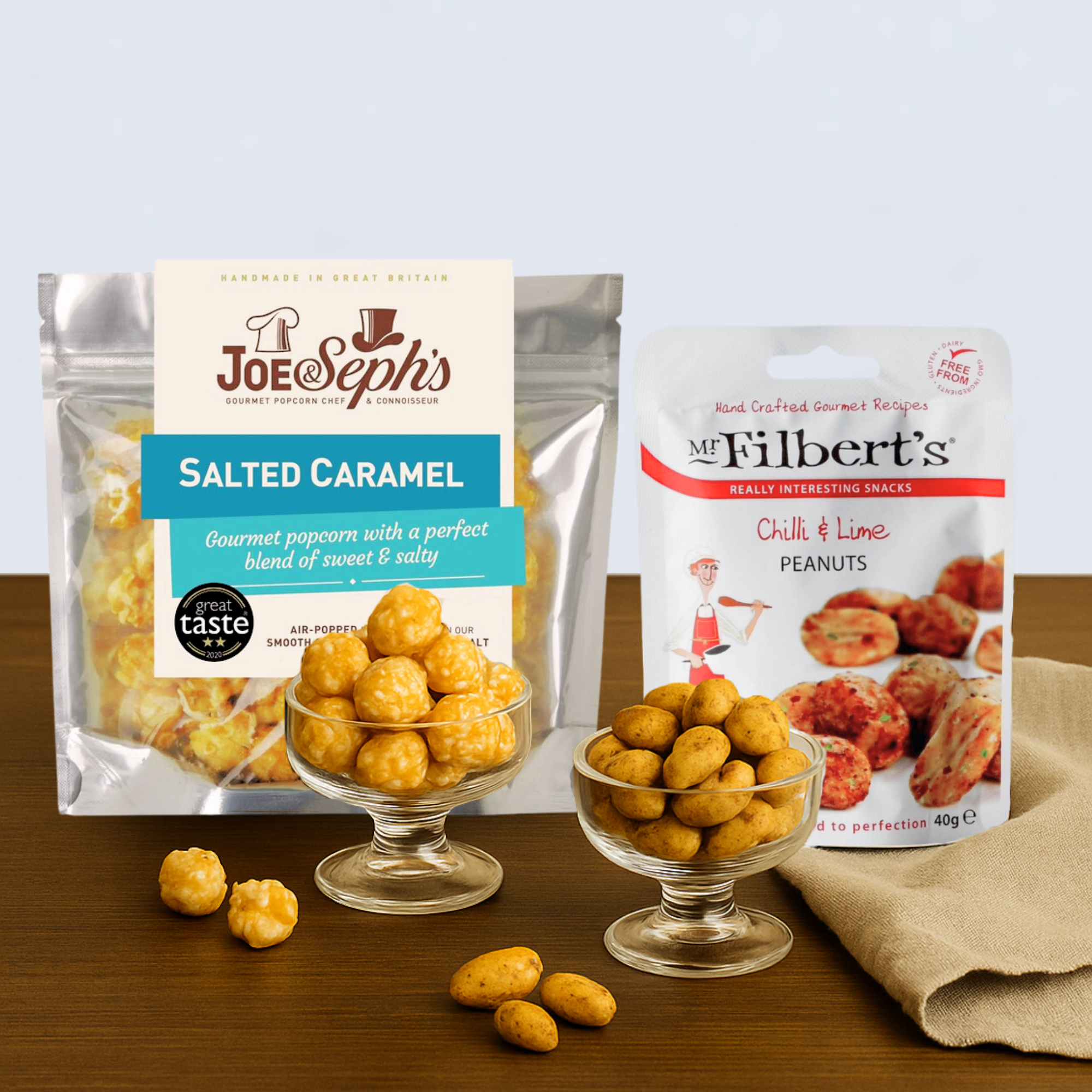 Joe & Seph’s Salted Caramel Gourmet Popcorn and Mr Filbert’s Chilli & Lime Peanuts, displayed side by side in a premium snack gift hamper