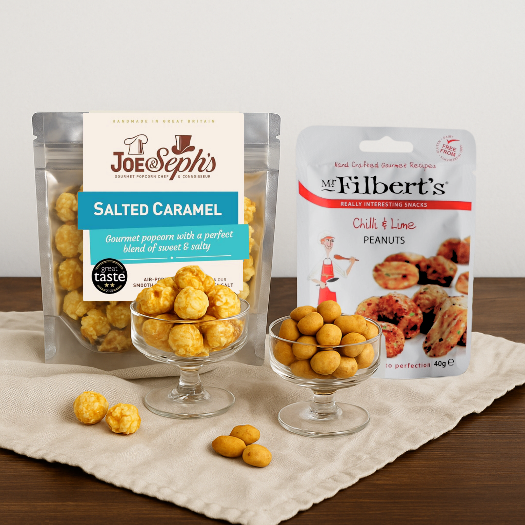 Close-up of Joe & Seph’s salted caramel gourmet popcorn and Mr Filberts chilli & lime peanuts