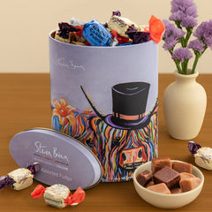 Gardiners of Scotland McHappily Couple Assorted Fudge tin featuring Steven Brown’s joyful Highland cow couple artwork—filled with a selection of traditional Scottish fudge flavours