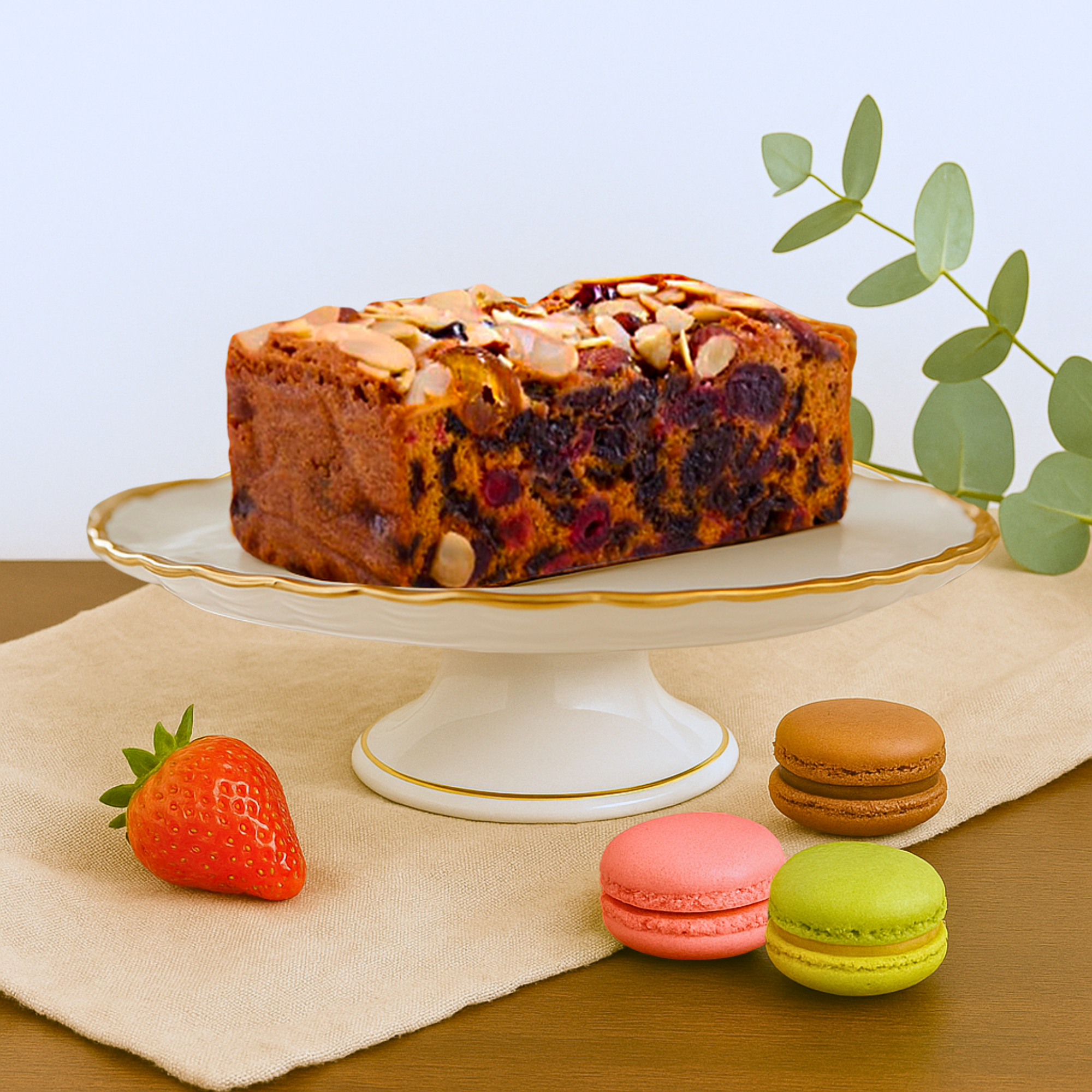 Rich butter fruit and nut loaf cake by The Original Cake Company, topped with almonds and cherries, ideal for afternoon tea gifting